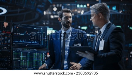 Two Successful Traders Analyzing Real-Time Financial Data and Reports About the State of the Finance Market. Stock Exchange Professionals Discussing Buy and Sell Options For Different Bonds