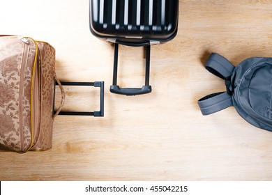 
two suitcases and a backpack lying on the floor at home