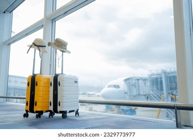 Two suitcases in an empty airport hall, traveler cases in the departure airport terminal waiting for the area, vacation concept, blank space for text message or design