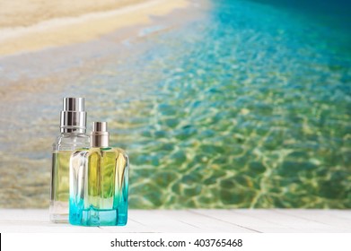 Two Summer Perfumes On White Wooden Table Against Defocused Coastline.