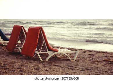 Two Sun Loungers, Bad Weather, Big Waves