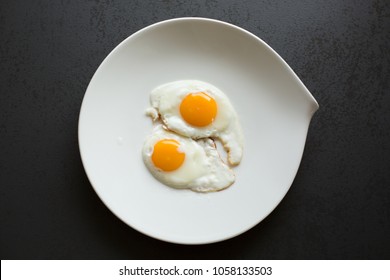 Two Sunny Side Up Eggs On Plate Above