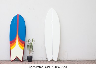 two surfboards on the street near the wall for hire rent - Powered by Shutterstock