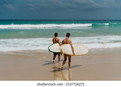 Two Surfers Enter The Ocean 