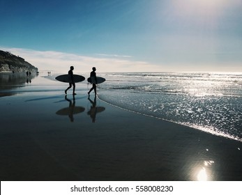 Two Surfers On The Beach In San Diego