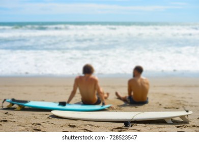 Two surfers with surfboards resting on the beach. Selective focus on the surfboard. Bali island, Indonesia - Powered by Shutterstock