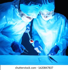Two surgeons perform a complex operation to remove a cancer tumor. Oncology Surgery Concept, general surgery