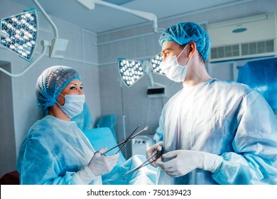 The two surgeons in uniform in surgery - Shutterstock ID 750139423