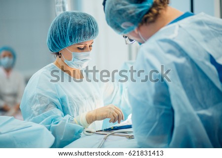 two surgeons at work in operating room. close up