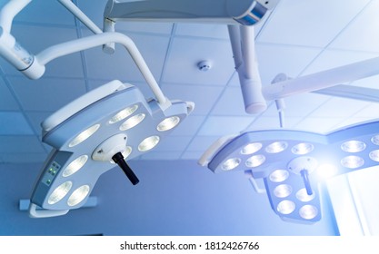 Two Surgical Lamps In Operation Room. Blue Cast Light In Clinic. Modern Equipment In Surgery Room. Operating Theatre. Closeup.