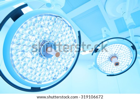 Two surgical lamps in operation room take with art lighting and blue filte
