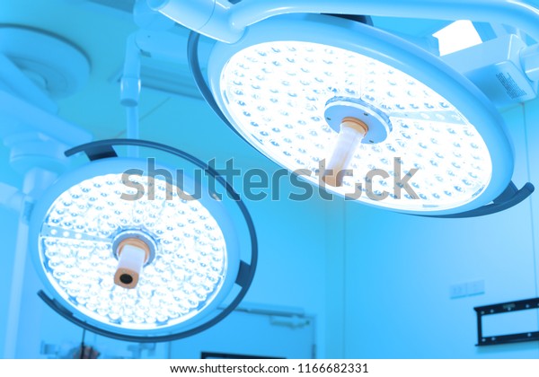 Two surgical lamps in operation room take with art\
lighting and blue filter
