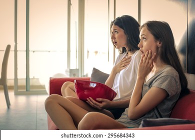 Two Surprised Girls Watching Tv