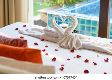 Two Swans And Heart Made From Towels On Honeymoon Bed