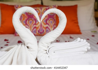 Two Swans And Heart Made From Towels On Honeymoon Bed