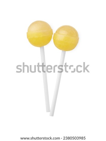 Two sweet yellow lollipops isolated on white, top view