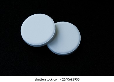 Two Tablets Of Aspirin Isolated On The Black Background. 