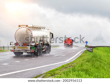 Similar – Foto Bild Zwei Tanklastzüge überqueren eine Autobahn über eine Brücke, Luftaufnahme.