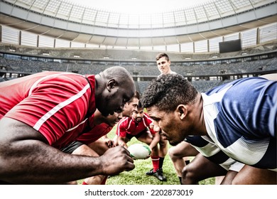 Two teams of multi-ethnic rugby players playing rugby at a sports stadium, wearing team strip, facing each other, one player holding a rugby ball. Sport and competition concept digital composite. - Powered by Shutterstock