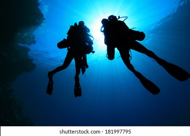 Two Tech Divers using rebreathers silhouette
