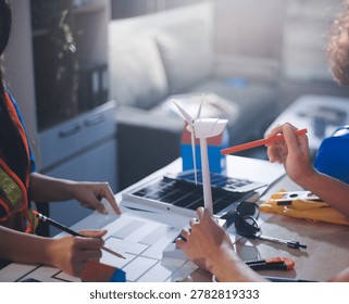 Two technicians inspect server racks in data center with tablet and fiber optic cable. Engineer and specialist discuss maintenance work in data center. Man and woman work together with safety equipmen