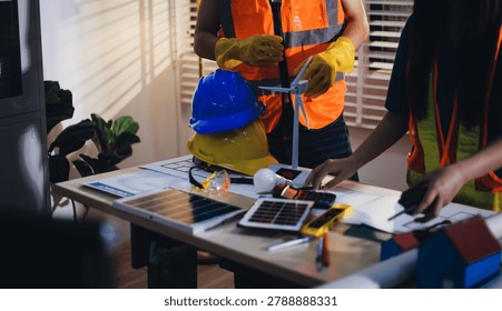 Two technicians inspect server racks in data center with tablet and fiber optic cable. Engineer and specialist discuss maintenance work in data center. Man and woman work together with safety equipmen
