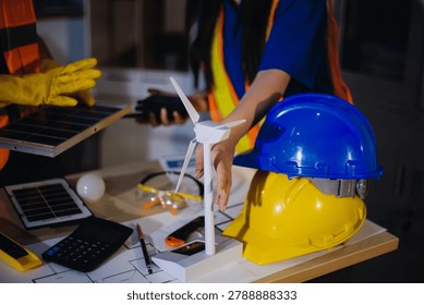 Two technicians inspect server racks in data center with tablet and fiber optic cable. Engineer and specialist discuss maintenance work in data center. Man and woman work together with safety equipmen
