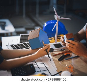 Two technicians inspect server racks in data center with tablet and fiber optic cable. Engineer and specialist discuss maintenance work in data center. Man and woman work together with safety equipmen