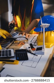 Two technicians inspect server racks in data center with tablet and fiber optic cable. Engineer and specialist discuss maintenance work in data center. Man and woman work together with safety equipmen