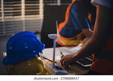 Two technicians inspect server racks in data center with tablet and fiber optic cable. Engineer and specialist discuss maintenance work in data center. Man and woman work together with safety equipmen