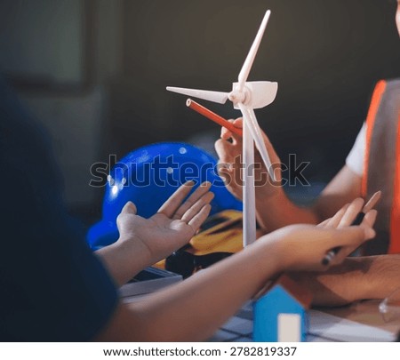 Two technicians inspect server racks in data center with tablet and fiber optic cable. Engineer and specialist discuss maintenance work in data center. Man and woman work together with safety equipmen
