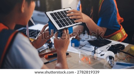 Two technicians inspect server racks in data center with tablet and fiber optic cable. Engineer and specialist discuss maintenance work in data center. Man and woman work together with safety equipmen