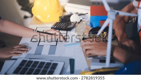 Two technicians inspect server racks in data center with tablet and fiber optic cable. Engineer and specialist discuss maintenance work in data center. Man and woman work together with safety equipmen
