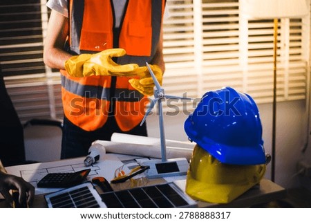 Two technicians inspect server racks in data center with tablet and fiber optic cable. Engineer and specialist discuss maintenance work in data center. Man and woman work together with safety equipmen