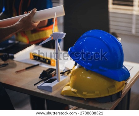 Two technicians inspect server racks in data center with tablet and fiber optic cable. Engineer and specialist discuss maintenance work in data center. Man and woman work together with safety equipmen