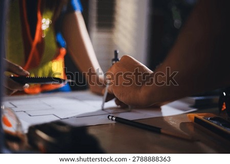 Two technicians inspect server racks in data center with tablet and fiber optic cable. Engineer and specialist discuss maintenance work in data center. Man and woman work together with safety equipmen