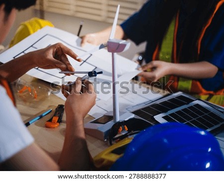 Two technicians inspect server racks in data center with tablet and fiber optic cable. Engineer and specialist discuss maintenance work in data center. Man and woman work together with safety equipmen