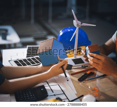 Two technicians inspect server racks in data center with tablet and fiber optic cable. Engineer and specialist discuss maintenance work in data center. Man and woman work together with safety equipmen