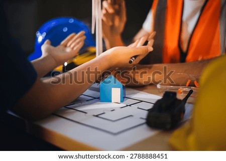 Two technicians inspect server racks in data center with tablet and fiber optic cable. Engineer and specialist discuss maintenance work in data center. Man and woman work together with safety equipmen
