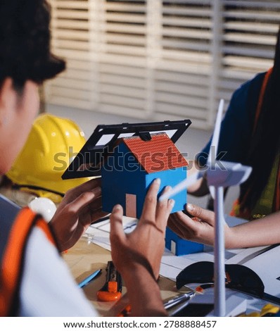 Two technicians inspect server racks in data center with tablet and fiber optic cable. Engineer and specialist discuss maintenance work in data center. Man and woman work together with safety equipmen