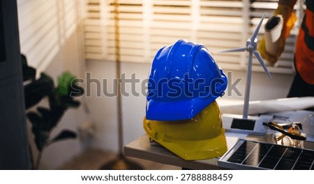 Two technicians inspect server racks in data center with tablet and fiber optic cable. Engineer and specialist discuss maintenance work in data center. Man and woman work together with safety equipmen