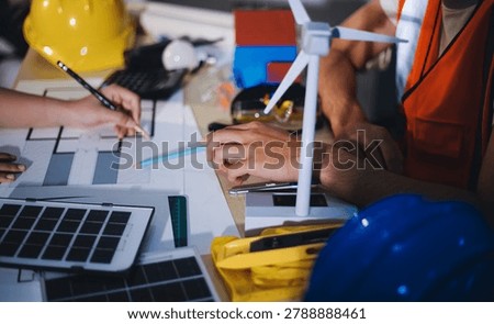 Two technicians inspect server racks in data center with tablet and fiber optic cable. Engineer and specialist discuss maintenance work in data center. Man and woman work together with safety equipmen