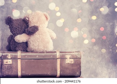 two teddy bears holding in one's arms 