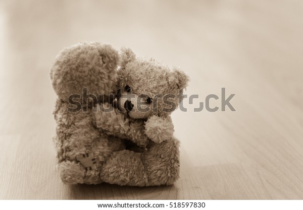 two teddy bears hugging