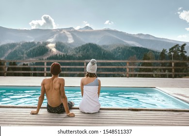 Two Teen Friends Spending Winter Or Spring Vacation In Luxury Spa Resort With Swimming Pool Over Alpine Mountain Landscape