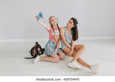 Two Teen Girls On The Skateboard Make Selfie.