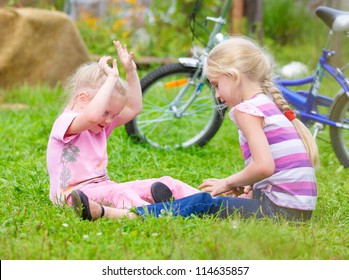 Two Teen Girls Playing On The Grass