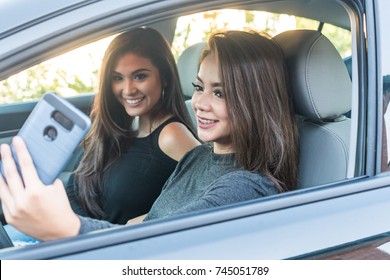 Two Teen Girls Texting While In The Car