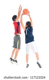 Two teenage boys playing basketball