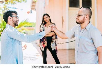 Two teenage friends bumping their fists outdoors. Concept of friends bumping fists amicably, Two overjoyed male friends bumping fists amicably on the street - Shutterstock ID 2192958063